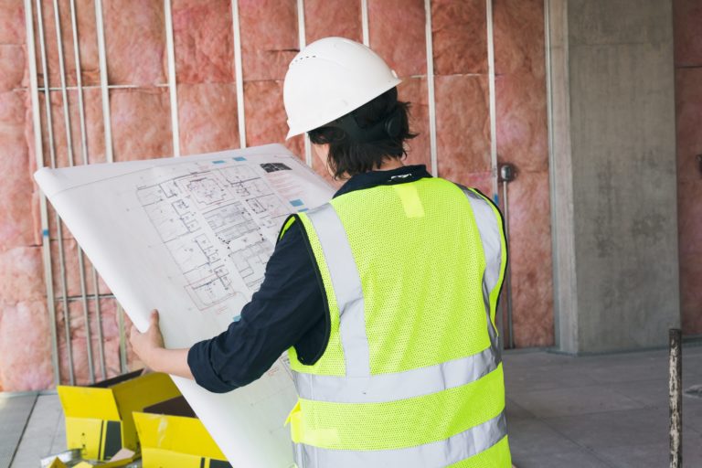 construction-worker-holding-blueprints-768x512-1